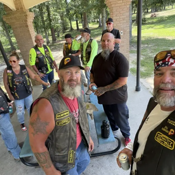 Riders gathered under a covered picnic pavilion during a stop.